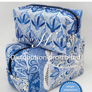 Pattern book for Rulerwork Panel Pouches by Amanda Murphy with blue and white pouches on a gray background.