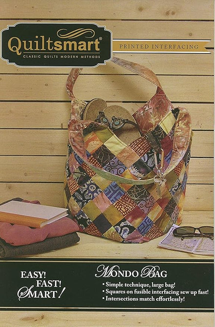 Quiltsmart Mondo Bag with colorful patchwork design on a wooden surface