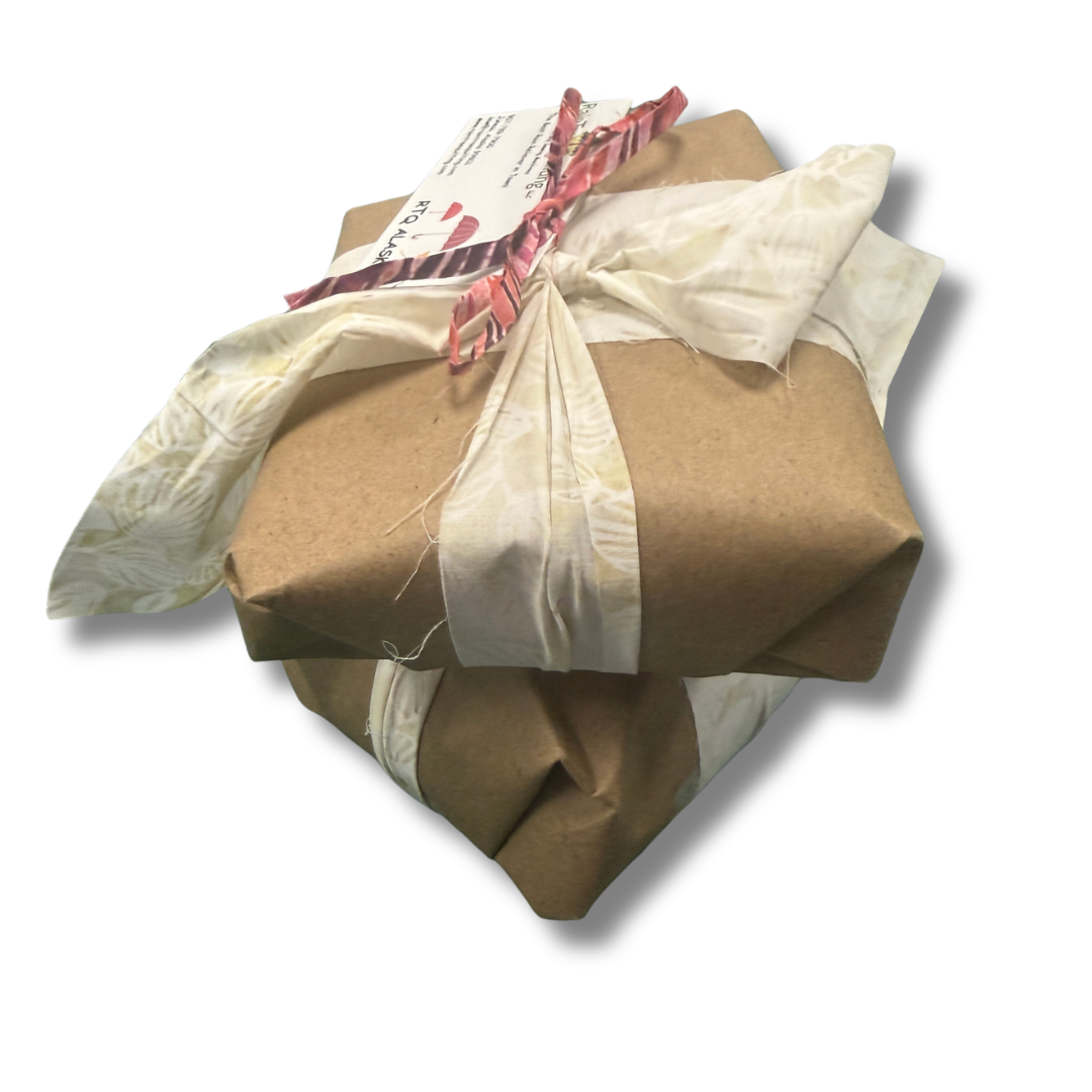 Package wrapped in brown paper with a white ribbon on a white background