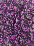 Floral patterned fabric with pink flowers on a dark background