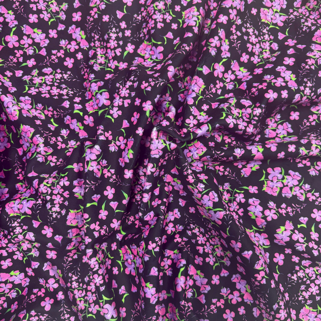 Floral patterned fabric with pink flowers on a dark background