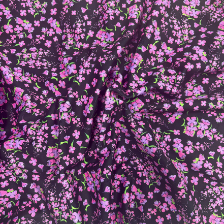 Floral patterned fabric with pink flowers on a dark background