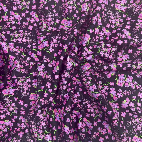Floral patterned fabric with pink flowers on a dark background