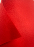 Close-up of red fabric with a textured surface