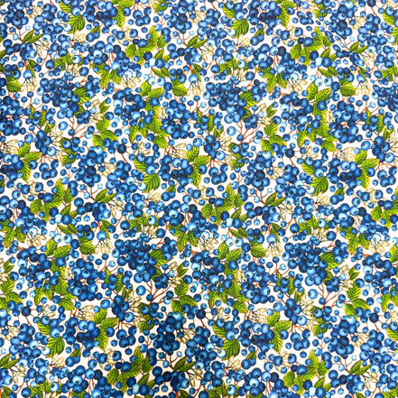 Pattern of blue berries and green leaves on a white background