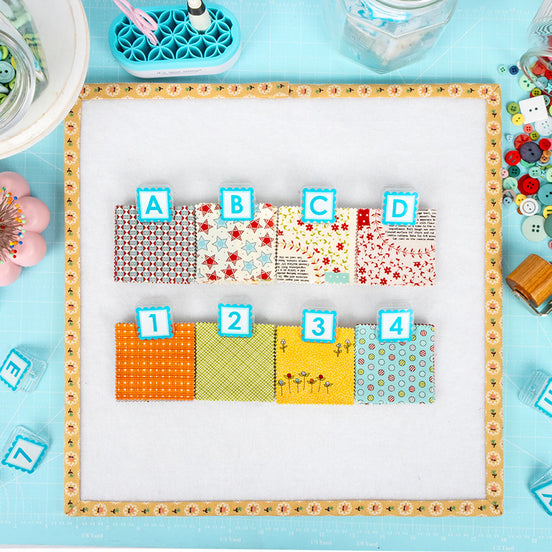 Colorful fabric swatches labeled A to D on a light blue background with sewing tools.