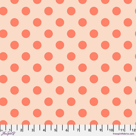Pattern of orange polka dots on a beige background with a ruler at the bottom.