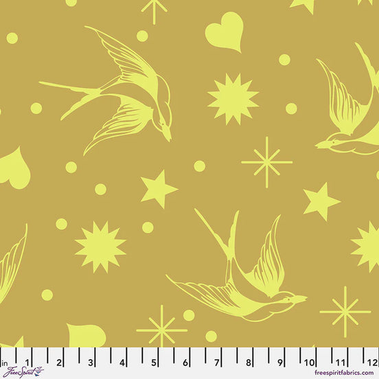 Fabric pattern with bright yellow birds and stars on a muted yellow background, featuring a ruler at the bottom.
