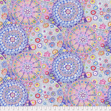 Colorful floral and geometric pattern fabric with a ruler at the bottom