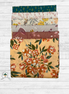 Set of floral-patterned fabric swatches on a wooden surface