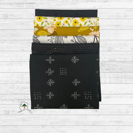 Set of fabric swatches with various patterns on a wooden surface
