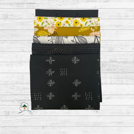 Set of fabric swatches with various patterns on a wooden surface