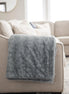 Living room with a gray sofa, rug, and decorative items