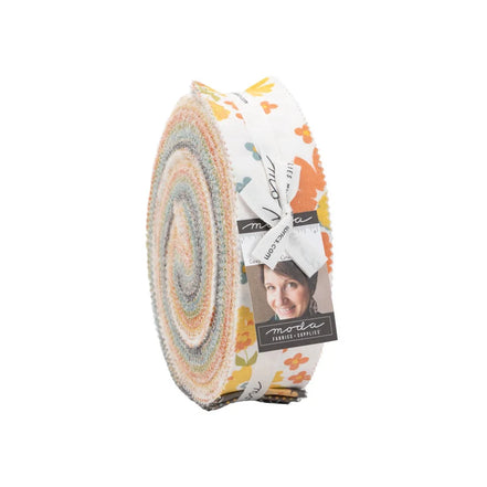 Fabric roll with circular pattern and visible brand label on a white background