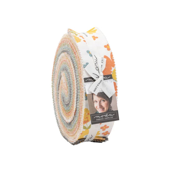 Fabric roll with circular pattern and visible brand label on a white background