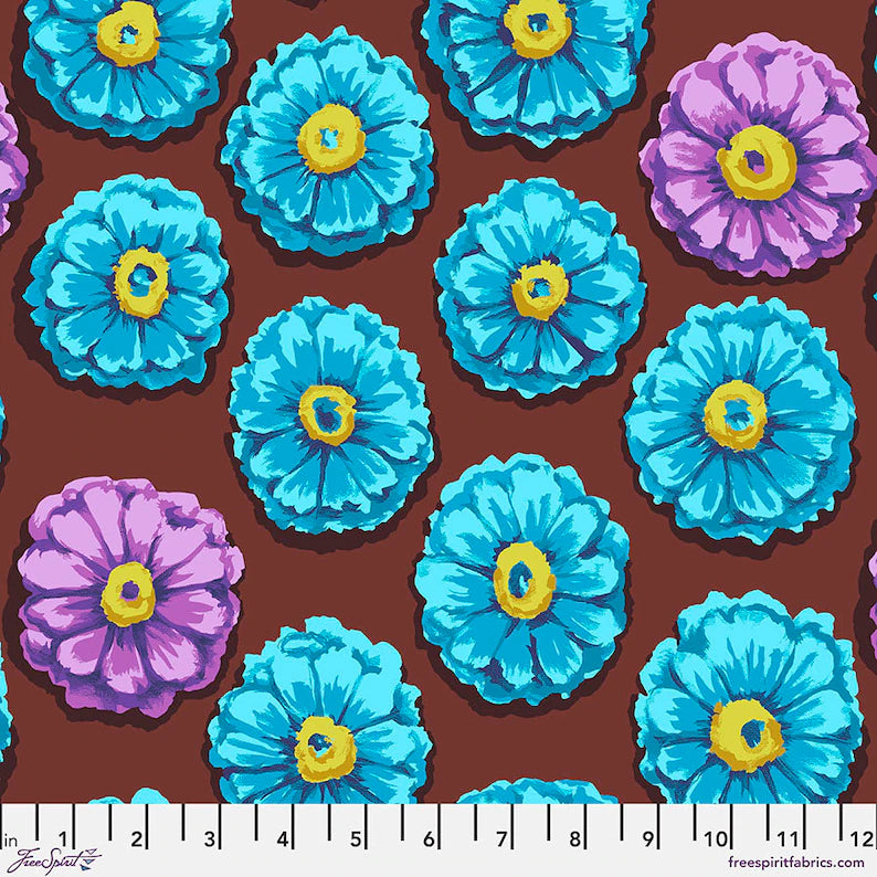 Pattern of blue and purple flowers with yellow centers on a brown background, featuring a ruler at the bottom.