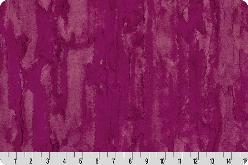 Textured purple fabric pattern with a ruler at the bottom