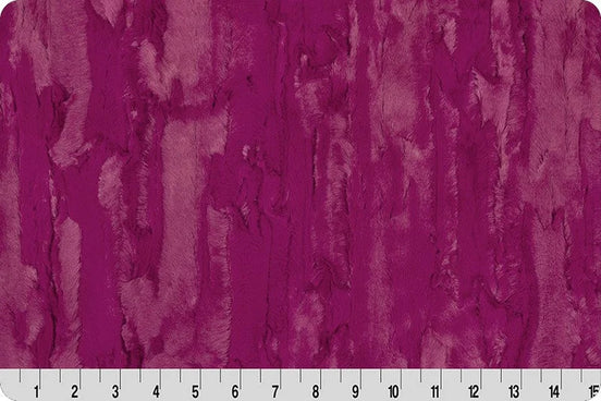 Textured purple fabric pattern with a ruler at the bottom
