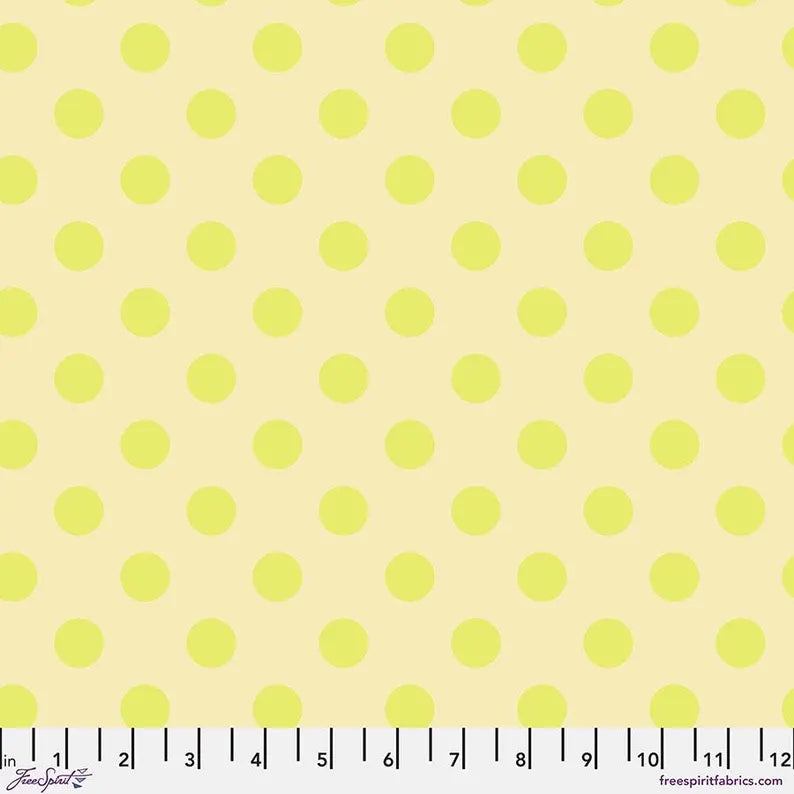Fabric with small yellow polka dots on a light yellow background