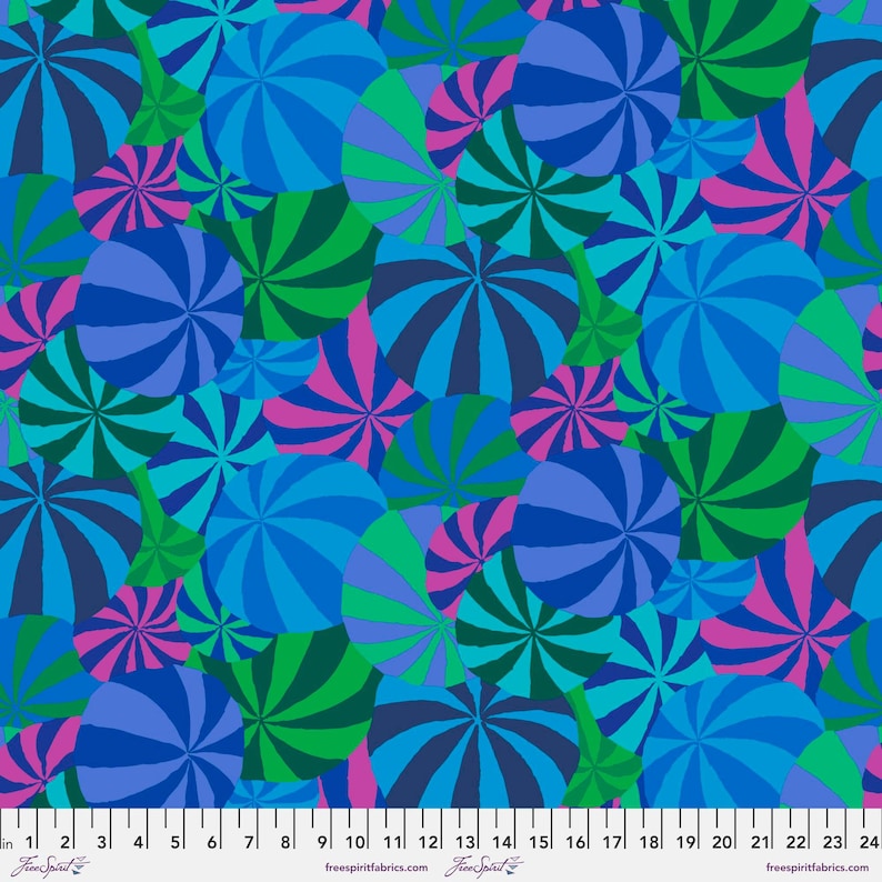 Colorful pattern of blue, green, and pink circles on a fabric swatch with a ruler at the bottom.