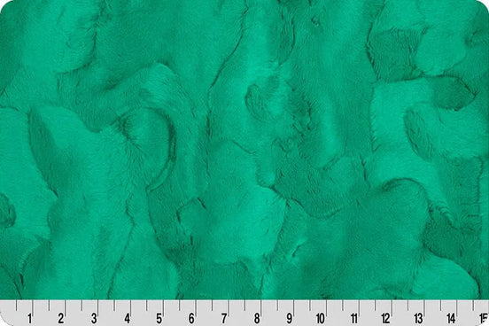 Textured green fabric with a ruler at the bottom