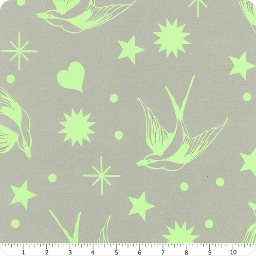 Fabric with green birds, stars, and hearts on a gray background