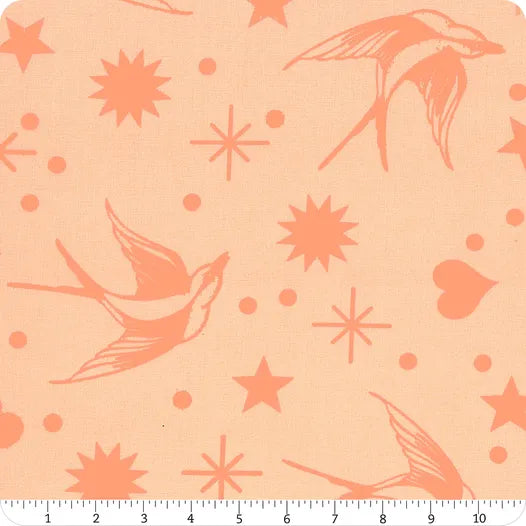 Pattern of birds and stars on a peach background with a ruler at the bottom.