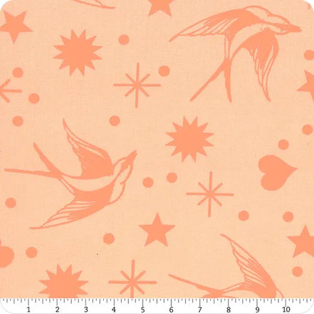 Pattern of birds and stars on a peach background with a ruler at the bottom.