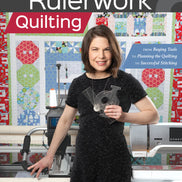 Book cover of 'The Ultimate Guide to Rulerwork Quilting' with a woman holding a ruler in a quilting studio.