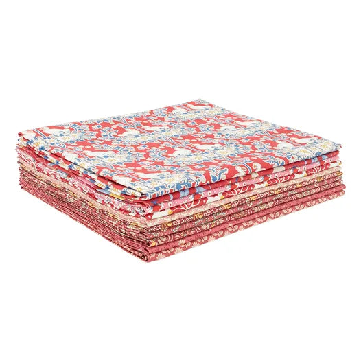 Stack of red and white patterned fabric pieces on a white background