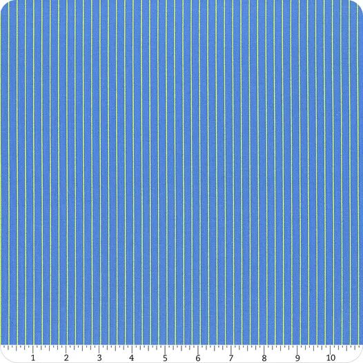 Blue fabric with tiny lime stripes with a ruler at the bottom for scale.
