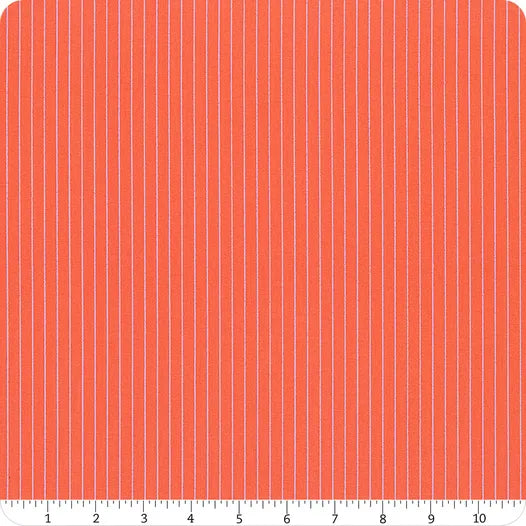 Fabric with vertical light blue stripes on a red background, measured against a ruler.
